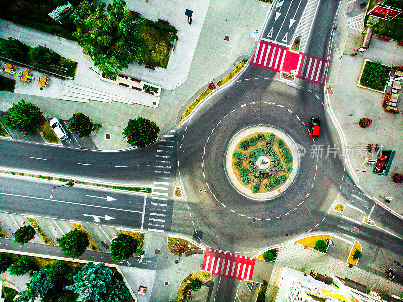 Aerial topdown view of car driving on roundabout in the city